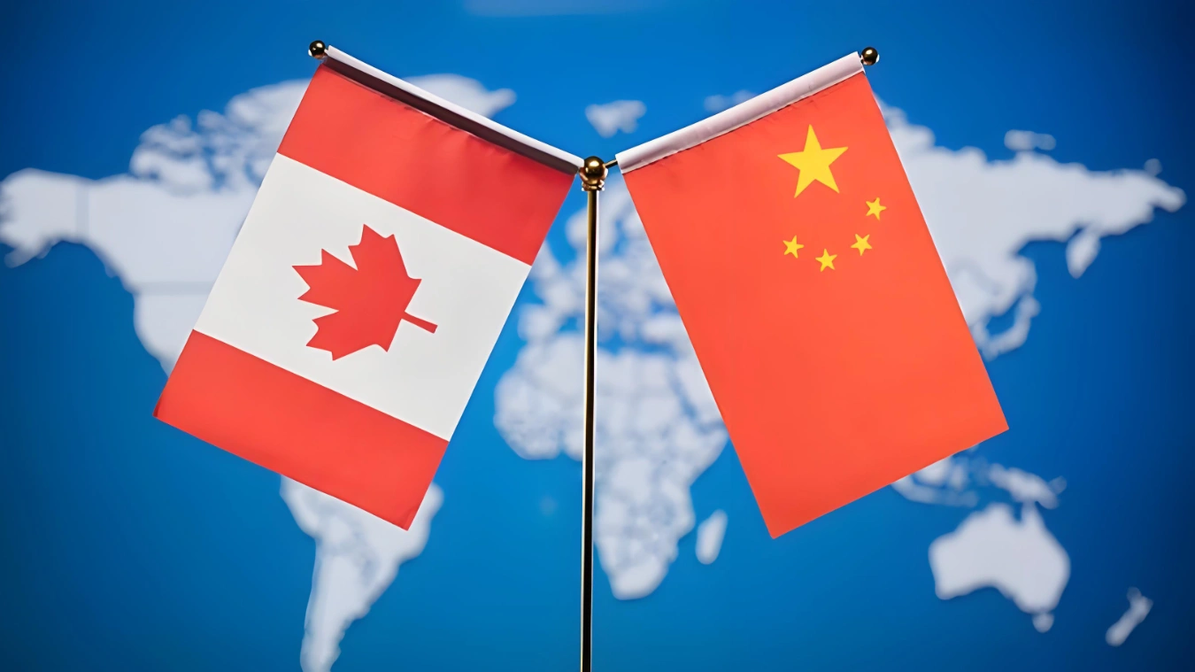 Canadian and Chinese flags displayed side by side on a world map background, symbolizing growing bilateral cooperation in global trade and fashion jewelry exports from Yiwu to North America.
